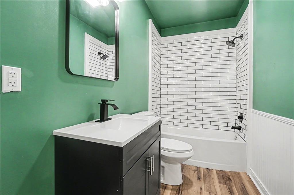 1004 Mapp Street Madison, GA 30650 - Photo 17 of 30 a bathroom with a sink toilet and shower