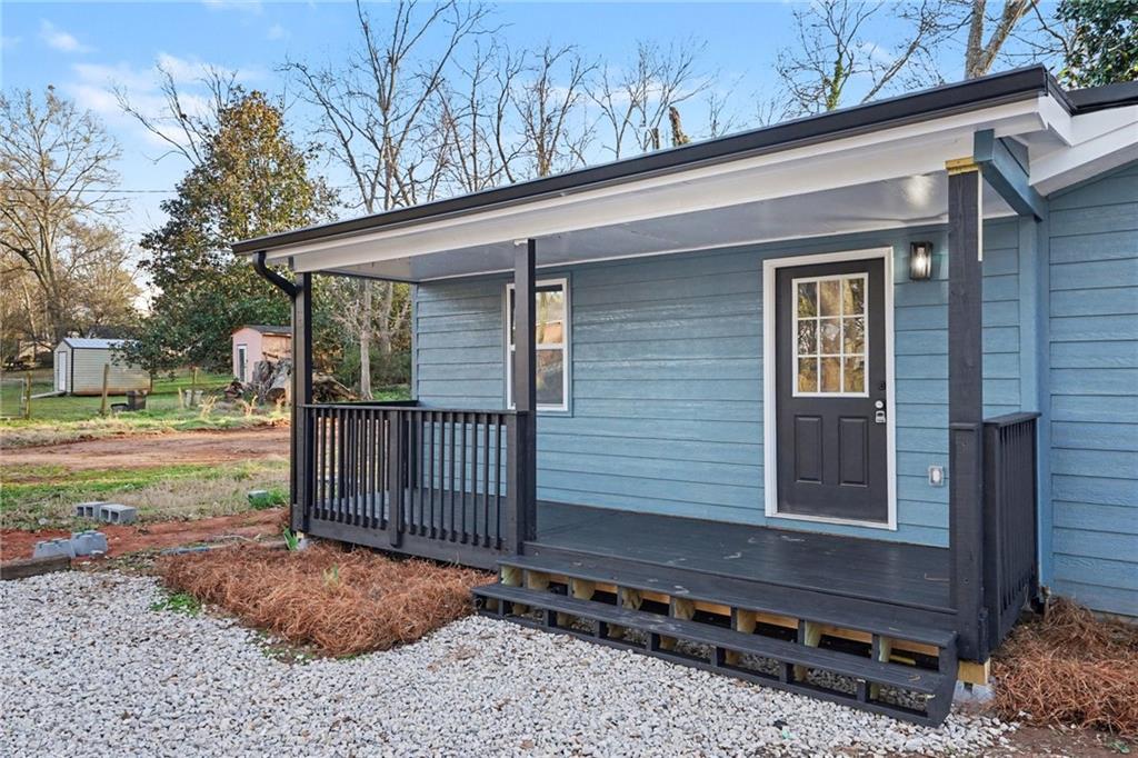 1004 Mapp Street Madison, GA 30650 - Photo 2 of 30 a view of a house with a yard and wooden fence