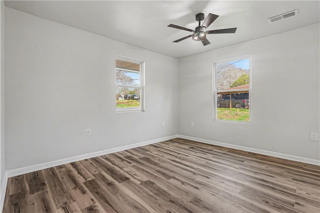 1004 Mapp Street Madison, GA 30650 - Photo 22 of 30 wooden floor in a empty room with a window