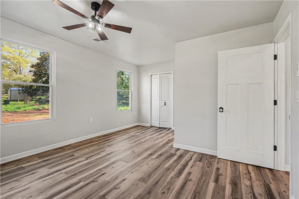 1004 Mapp Street Madison, GA 30650 - Photo 23 of 30 a view of empty room with wooden floor and fan