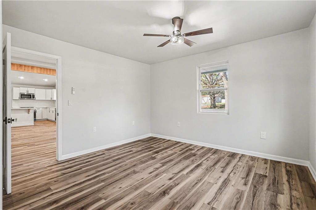 1004 Mapp Street Madison, GA 30650 - Photo 25 of 30 wooden floor in an empty room with a window