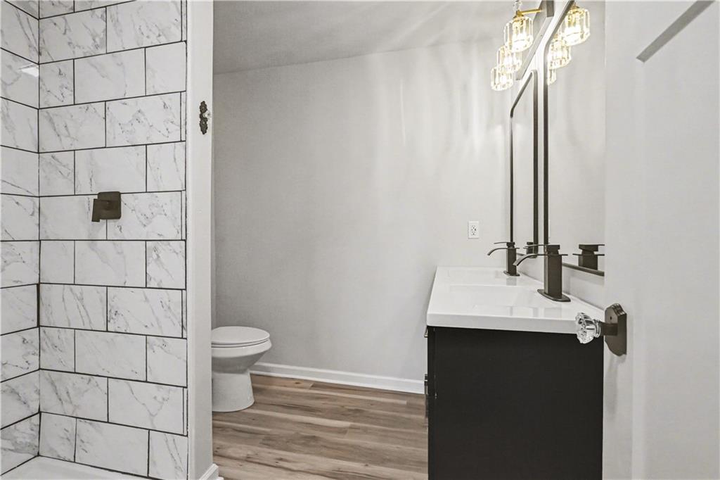 1004 Mapp Street Madison, GA 30650 - Photo 26 of 30 a bathroom with a sink toilet and shower