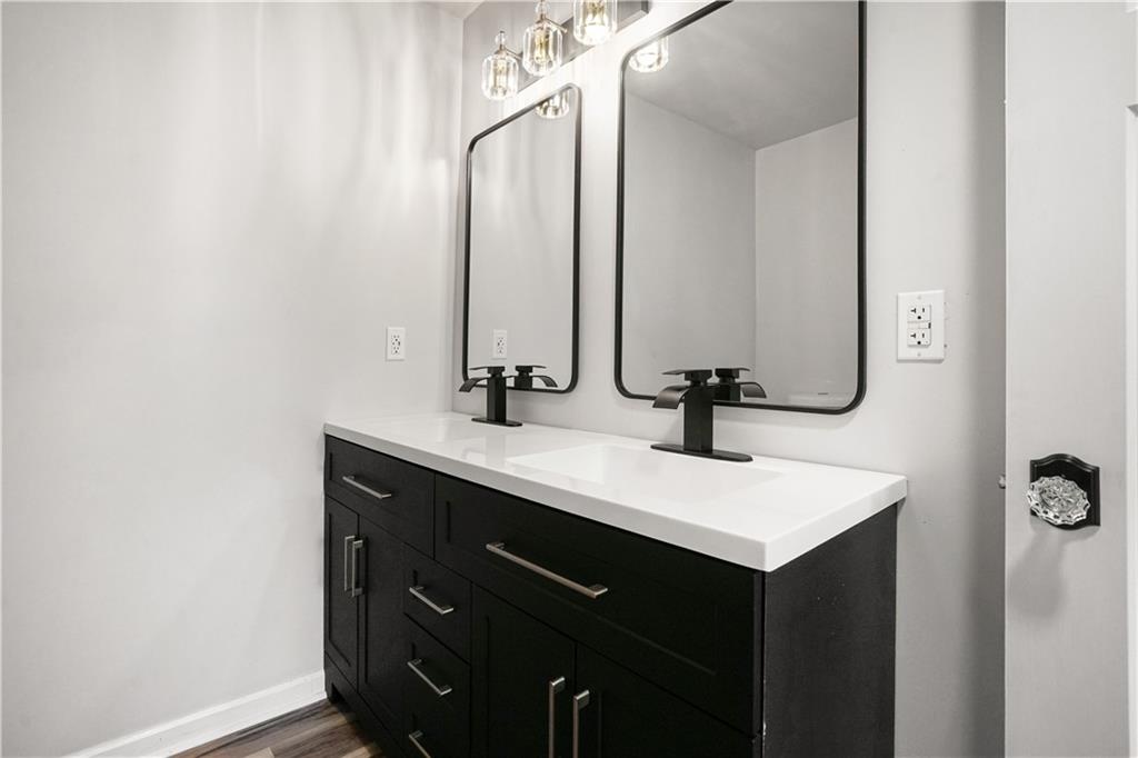 1004 Mapp Street Madison, GA 30650 - Photo 27 of 30 a bathroom with a sink vanity and a mirror