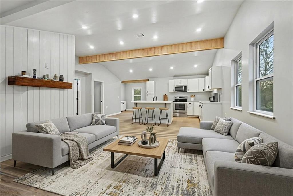 1004 Mapp Street Madison, GA 30650 - Photo 3 of 30 a living room with furniture kitchen view and a wooden floor