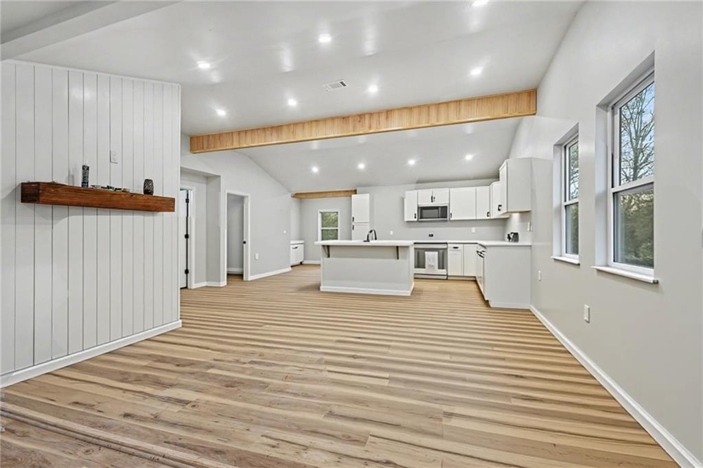 1004 Mapp Street Madison, GA 30650 - Photo 4 of 30 a view of kitchen with kitchen island a sink wooden floor and a refrigerator
