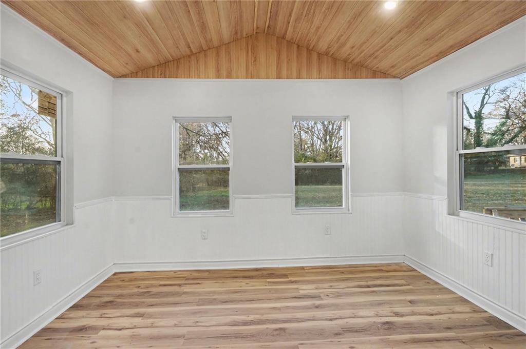 1004 Mapp Street Madison, GA 30650 - Photo 8 of 30 a view of an empty room with wooden floor and window