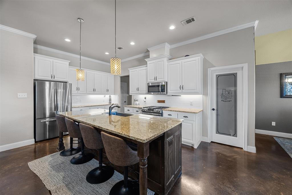 113 Treys Way Godley, TX 76044 - Photo 12 of 39 a kitchen with a center island appliances and cabinets