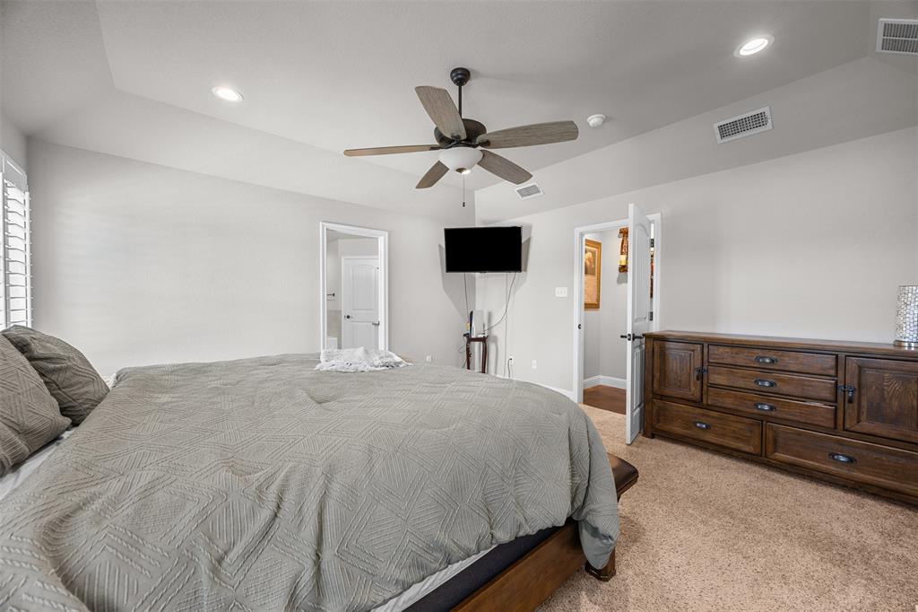 113 Treys Way Godley, TX 76044 - Photo 21 of 39 a bedroom with a bed and a chandelier