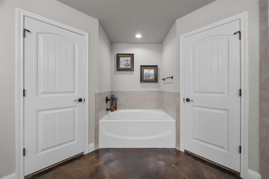 113 Treys Way Godley, TX 76044 - Photo 23 of 39 a bathroom with a bathtub and a shower