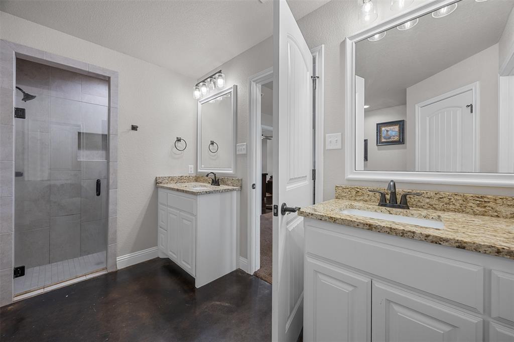 113 Treys Way Godley, TX 76044 - Photo 24 of 39 a bathroom with a granite countertop sink mirror and shower