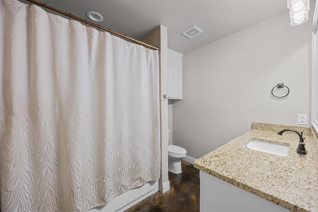 113 Treys Way Godley, TX 76044 - Photo 28 of 39 a bathroom with a granite countertop sink and a mirror