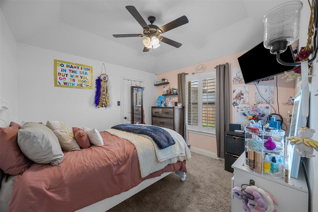 113 Treys Way Godley, TX 76044 - Photo 29 of 39 a spacious bedroom with a bed a flat screen tv and a ceiling fan