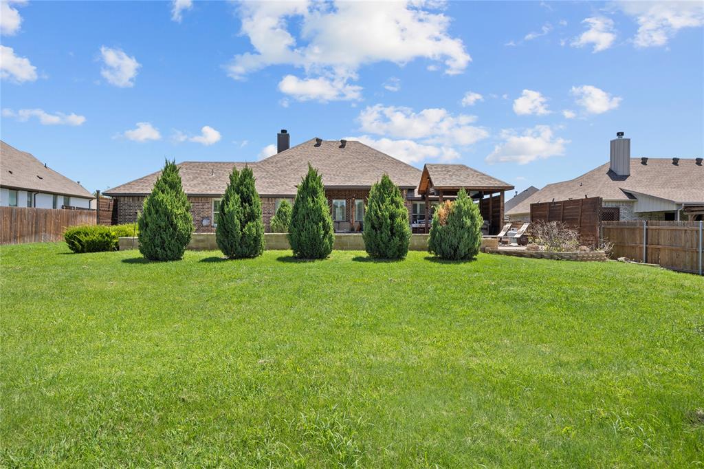 113 Treys Way Godley, TX 76044 - Photo 35 of 39 a front view of a house with garden