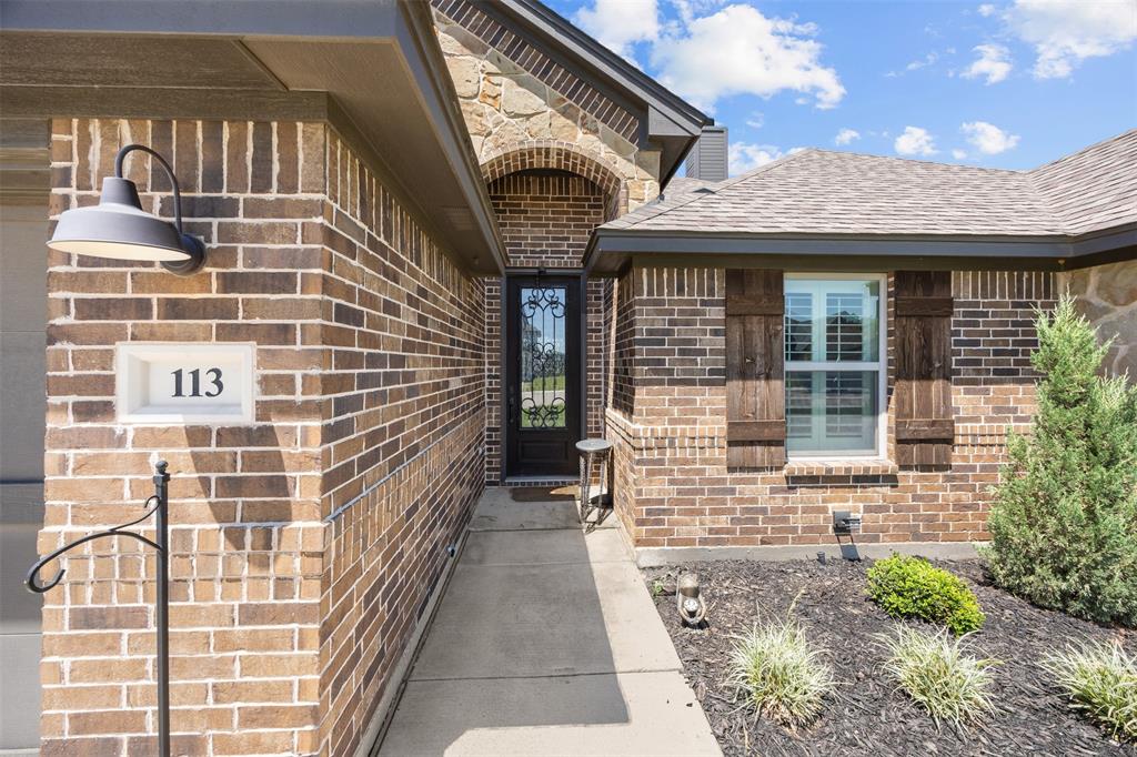 113 Treys Way Godley, TX 76044 - Photo 5 of 39 a view of a brick building with many windows