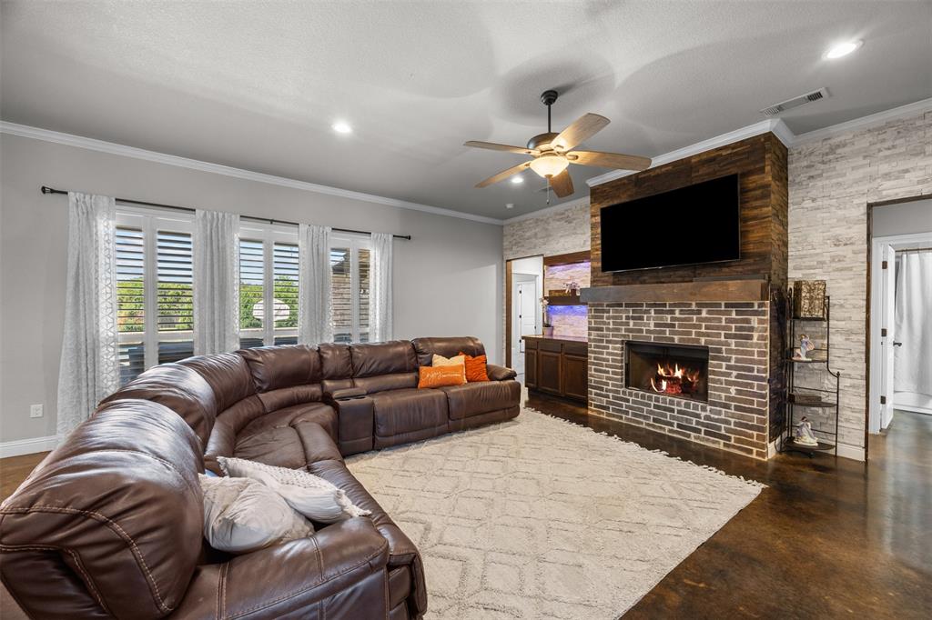 113 Treys Way Godley, TX 76044 - Photo 8 of 39 a living room with furniture a fireplace and a flat screen tv