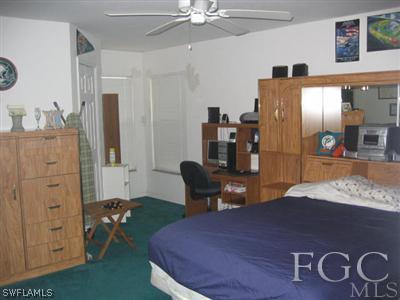 2010 Park Road Lehigh Acres, FL 33971 - Photo 5 of 9 a bedroom with a bed and furniture