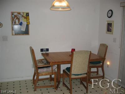 2010 Park Road Lehigh Acres, FL 33971 - Photo 6 of 9 a view of a dining room with furniture and wooden floor