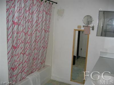 2010 Park Road Lehigh Acres, FL 33971 - Photo 7 of 9 a bathroom with a sink and a mirror