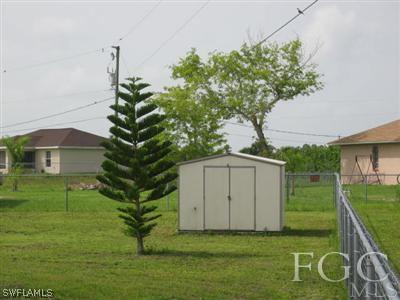 2010 Park Road Lehigh Acres, FL 33971 - Photo 8 of 9 a front view of a house with garden