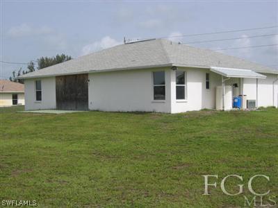 2010 Park Road Lehigh Acres, FL 33971 - Photo 9 of 9 a front view of a house with a garden