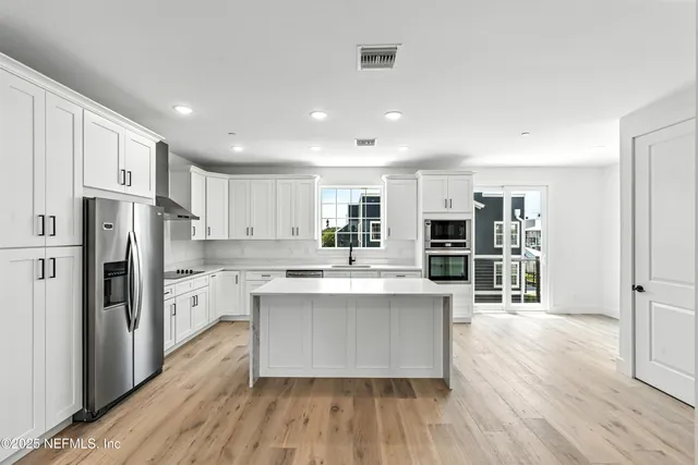 a view of an empty room with a fireplace and a window
