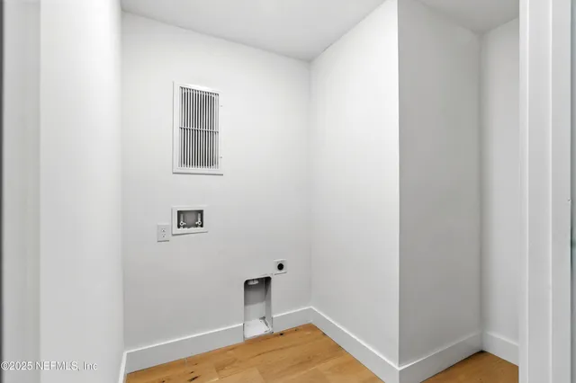 a front view of a building with a garden