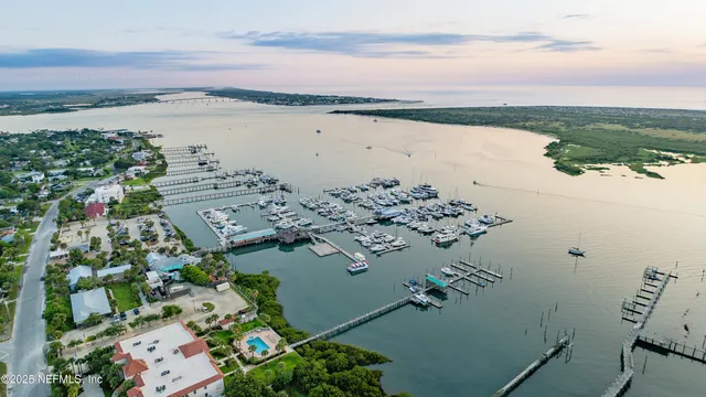 an aerial view of residential building with swimming pool and outdoor seating