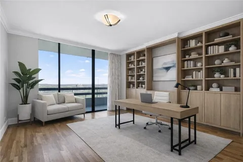 a view of a hallway with a livingroom and furniture