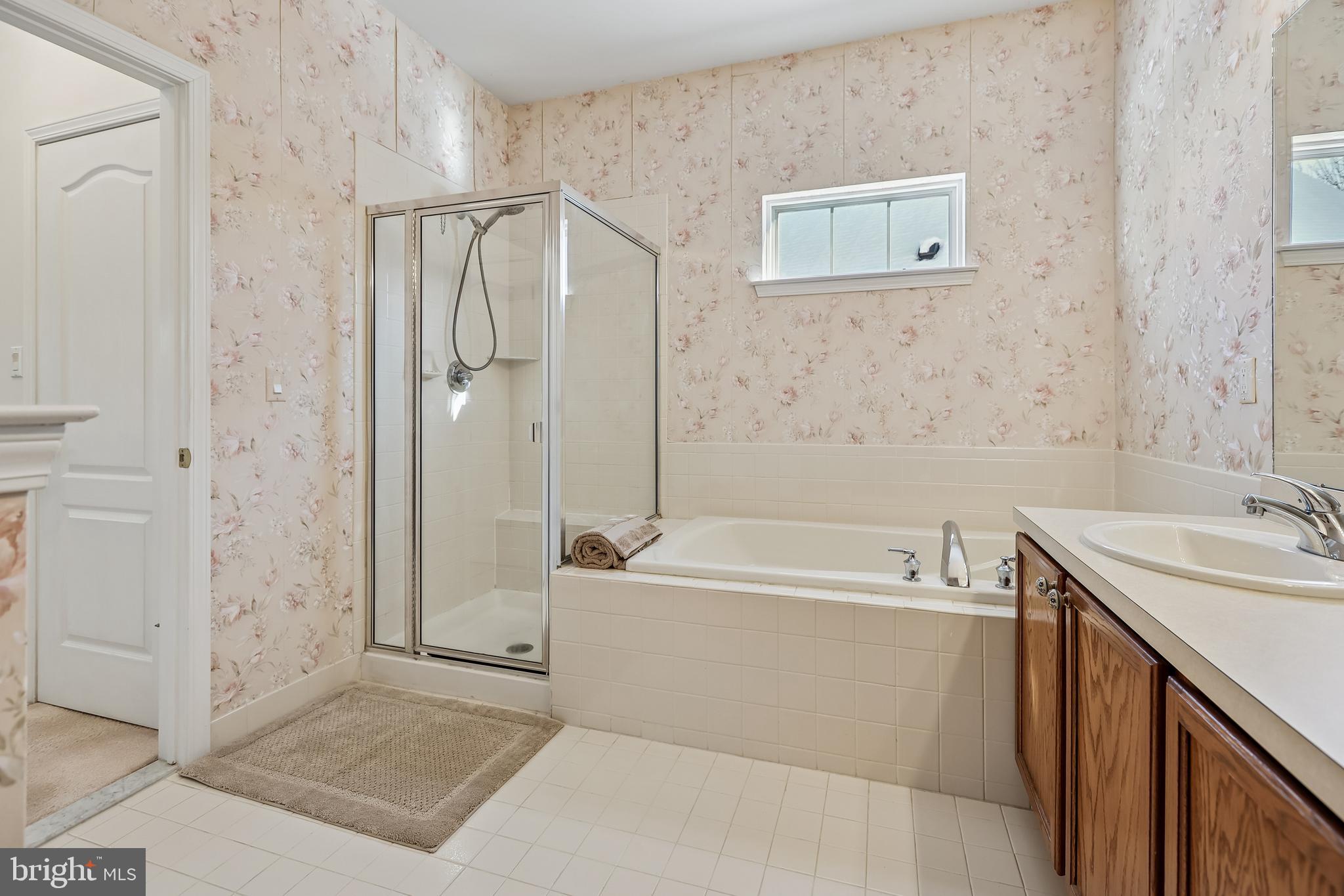 17 Pinflower Lane Princeton Junction, NJ 08550 - Photo 20 of 57 a bathroom with a tub a sink and a shower