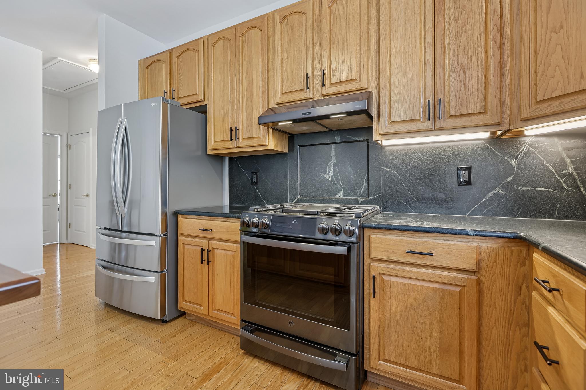 17 Pinflower Lane Princeton Junction, NJ 08550 - Photo 5 of 57 a kitchen with stainless steel appliances granite countertop a refrigerator stove and cabinets