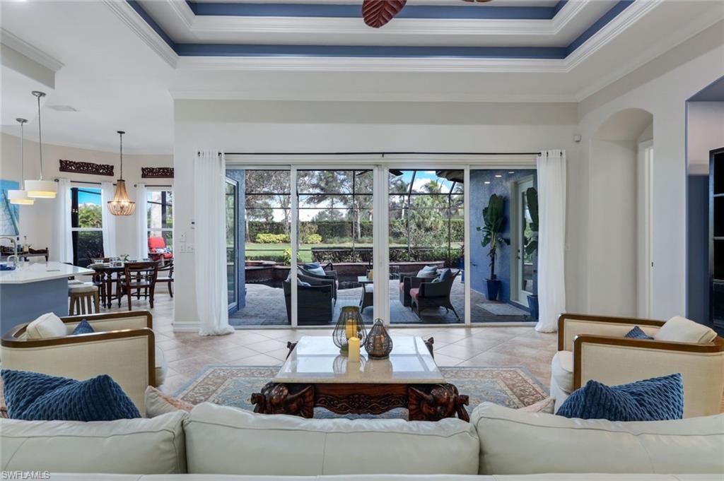 7688 Cottesmore Drive Naples, FL 34113 - Photo 11 of 45 a living room with furniture and a large window