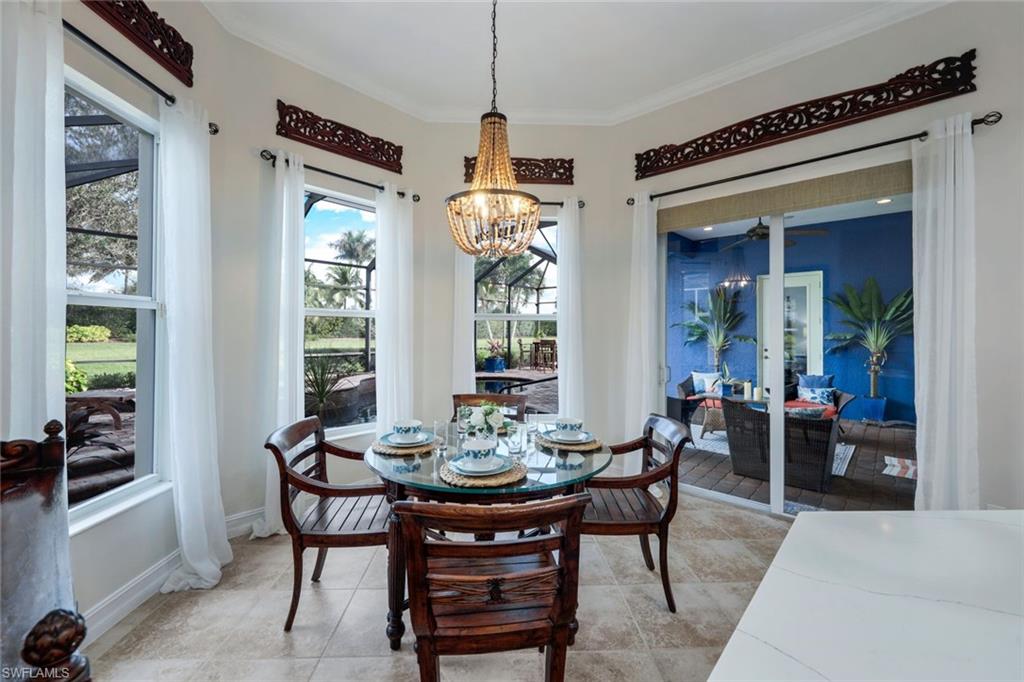 7688 Cottesmore Drive Naples, FL 34113 - Photo 16 of 45 a view of a dining room with furniture window and outside view