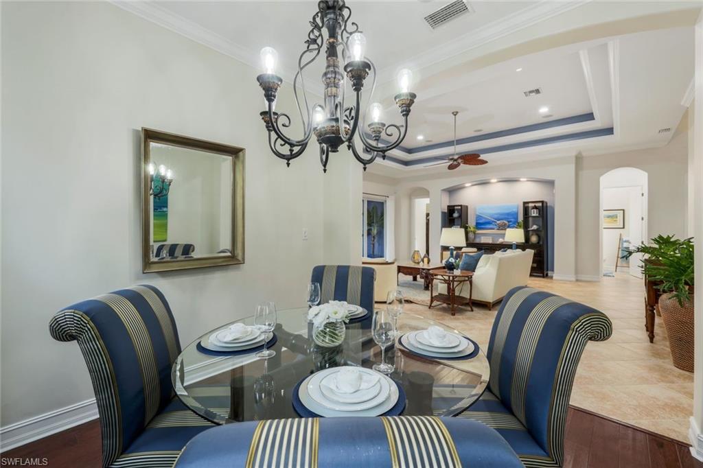 7688 Cottesmore Drive Naples, FL 34113 - Photo 18 of 45 a view of a dining room with furniture