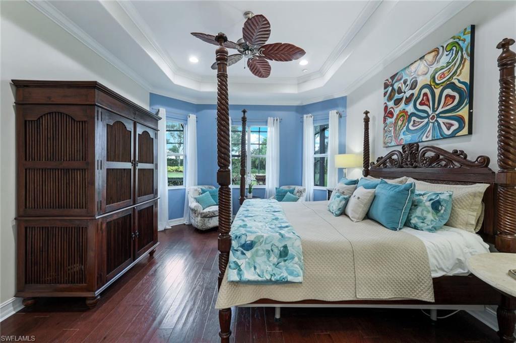 7688 Cottesmore Drive Naples, FL 34113 - Photo 20 of 45 a bedroom with a bed and wooden floor