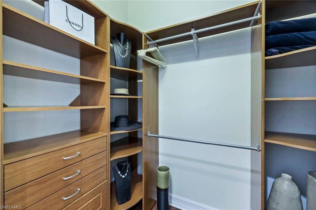 7688 Cottesmore Drive Naples, FL 34113 - Photo 21 of 45 a view of walk in closet with empty racks