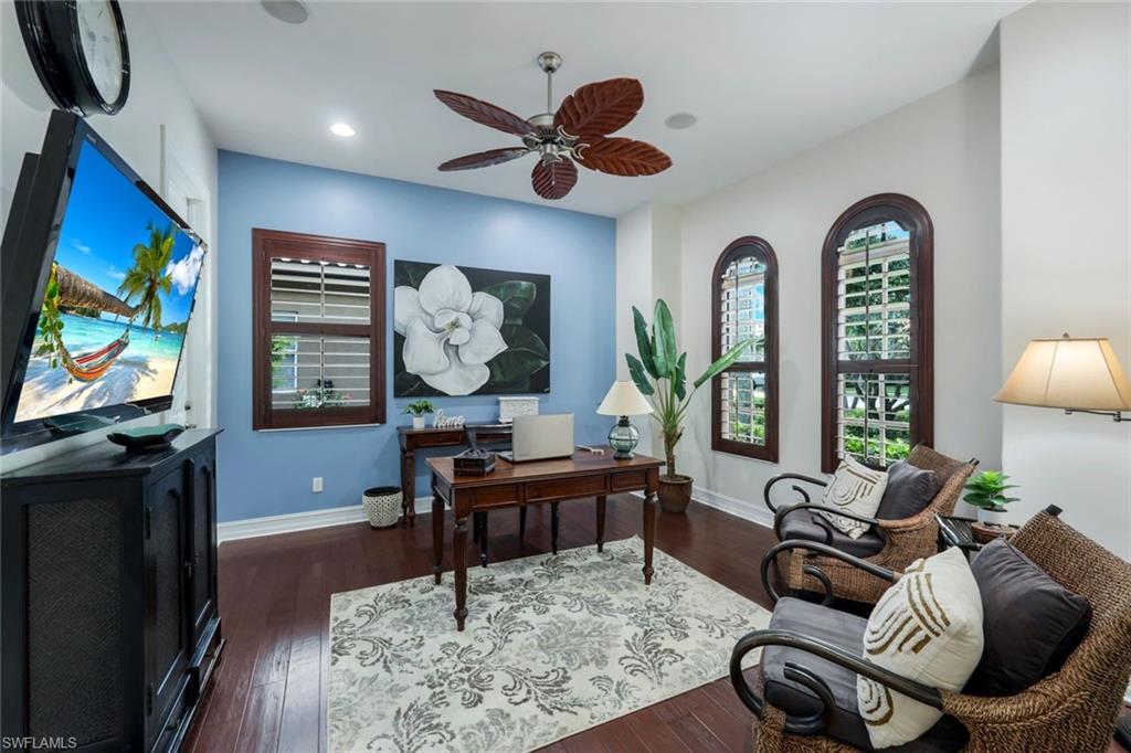 7688 Cottesmore Drive Naples, FL 34113 - Photo 26 of 45 a living room with furniture a window and a flat screen tv