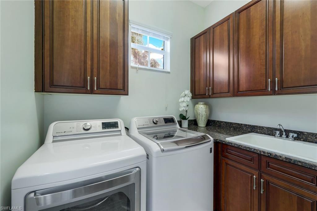 7688 Cottesmore Drive Naples, FL 34113 - Photo 29 of 45 a utility room with dryer and washer