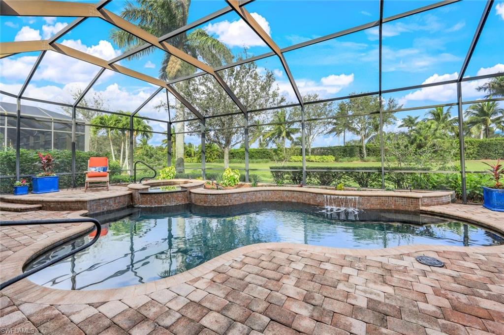 7688 Cottesmore Drive Naples, FL 34113 - Photo 3 of 45 a lake view with a sitting space