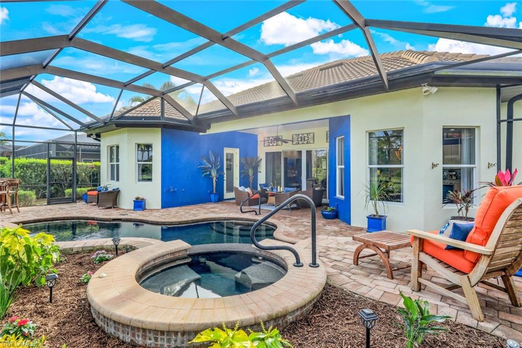 7688 Cottesmore Drive Naples, FL 34113 - Photo 33 of 45 a swimming pool with outdoor seating and patio