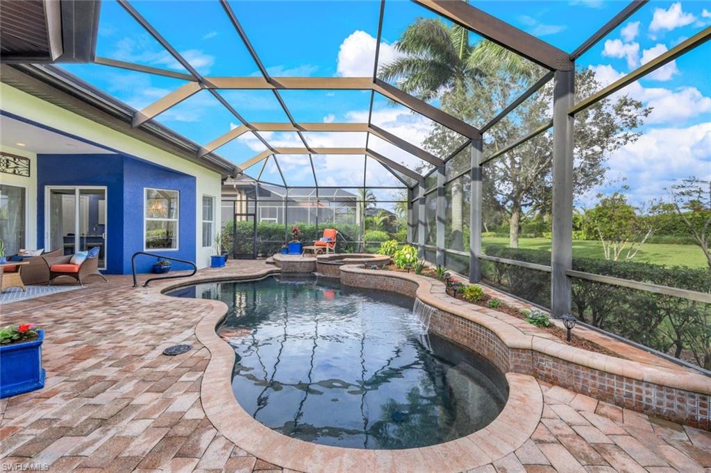 7688 Cottesmore Drive Naples, FL 34113 - Photo 34 of 45 a view of a swimming pool with a patio