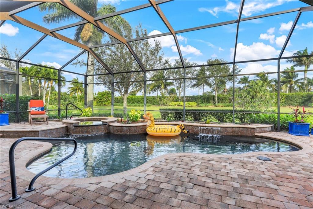 7688 Cottesmore Drive Naples, FL 34113 - Photo 35 of 45 a view of swimming pool with a back yard
