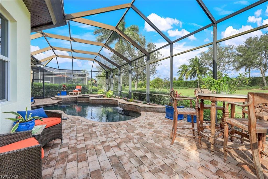 7688 Cottesmore Drive Naples, FL 34113 - Photo 36 of 45 a view of roof deck with a dining table and chairs with wooden floor