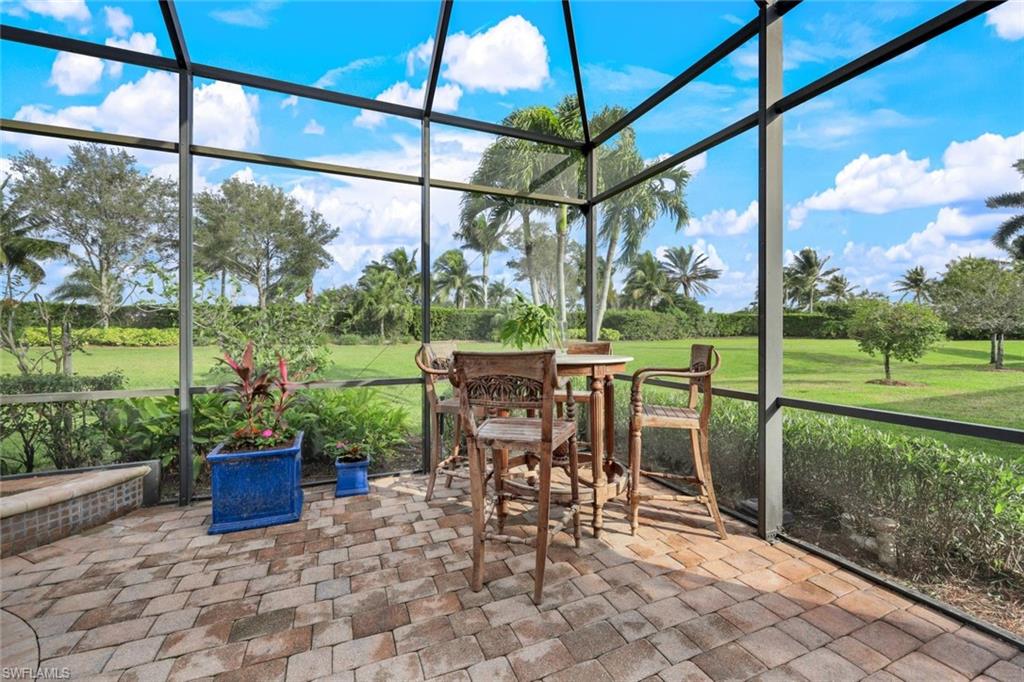 7688 Cottesmore Drive Naples, FL 34113 - Photo 37 of 45 a view of a porch with chairs and backyard