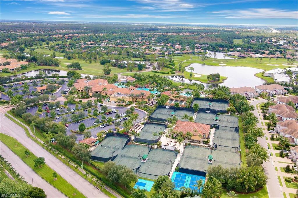 7688 Cottesmore Drive Naples, FL 34113 - Photo 44 of 45 an aerial view of residential building and lake