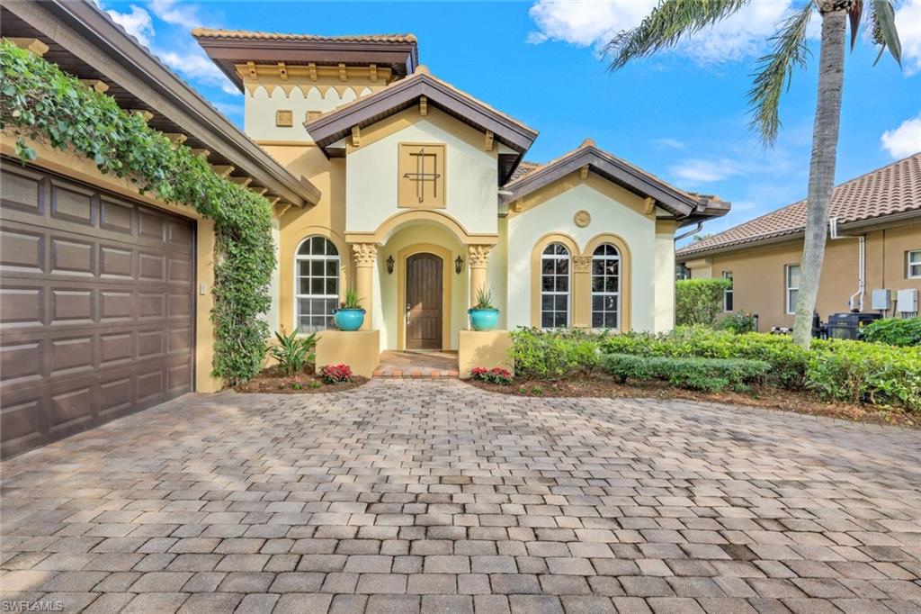 7688 Cottesmore Drive Naples, FL 34113 - Photo 6 of 45 a front view of a house with a yard