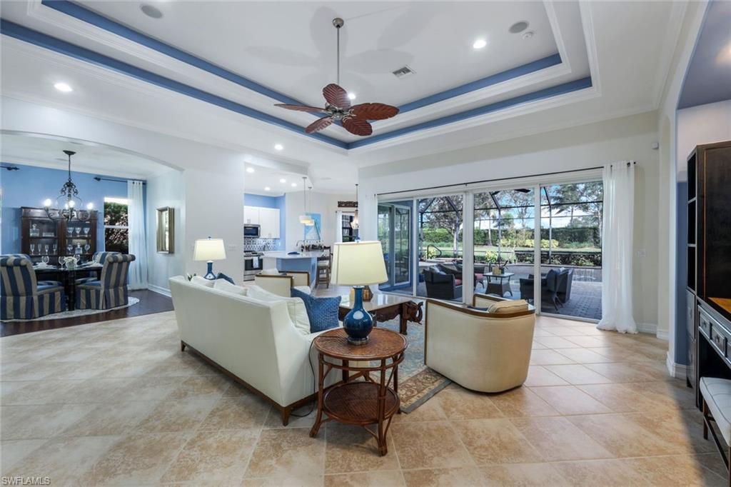 7688 Cottesmore Drive Naples, FL 34113 - Photo 8 of 45 a living room with furniture and a large window
