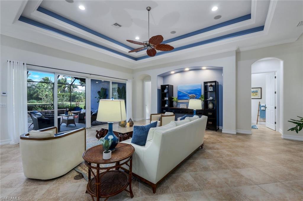 7688 Cottesmore Drive Naples, FL 34113 - Photo 9 of 45 a living room with furniture and a flat screen tv