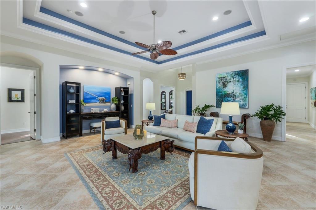 7688 Cottesmore Drive Naples, FL 34113 - Photo 10 of 45 a living room with furniture a rug and a flat screen tv