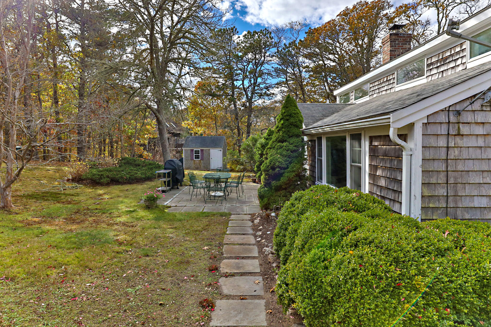 6 Cora Nickerson Road Harwich, MA 02645 - Photo 32 of 42 a view of a house with backyard sitting area and garden