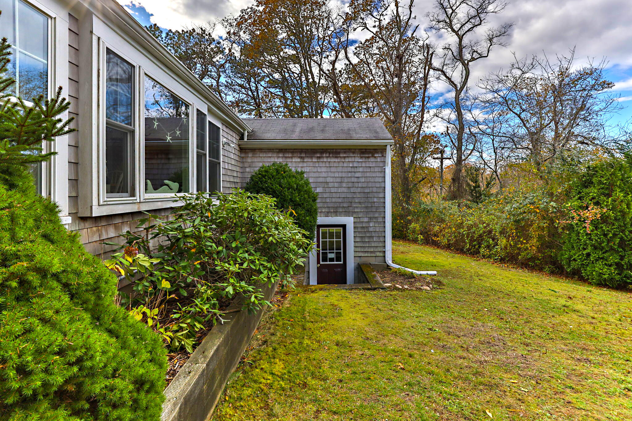 6 Cora Nickerson Road Harwich, MA 02645 - Photo 38 of 42 a view of house with backyard and glass windows